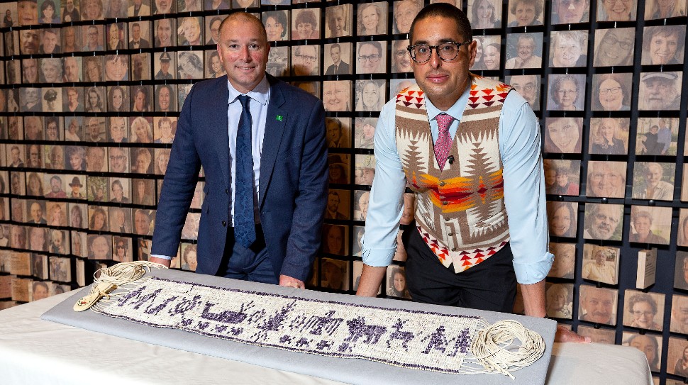 Plymouth City Council Leader Nick Kelly with Steven Peters, stood behind the Wampum belt